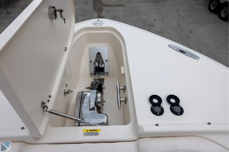 Slide: The Image of 2019 Grady-White Freedom 335 boat anchor compartment with open hatch and winch system. - 22