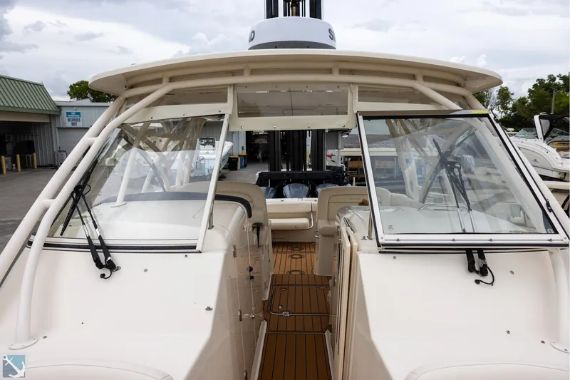 Slide: The Image of 2019 Grady-White Freedom 335 boat with spacious deck and windshield, docked at marina. - 23