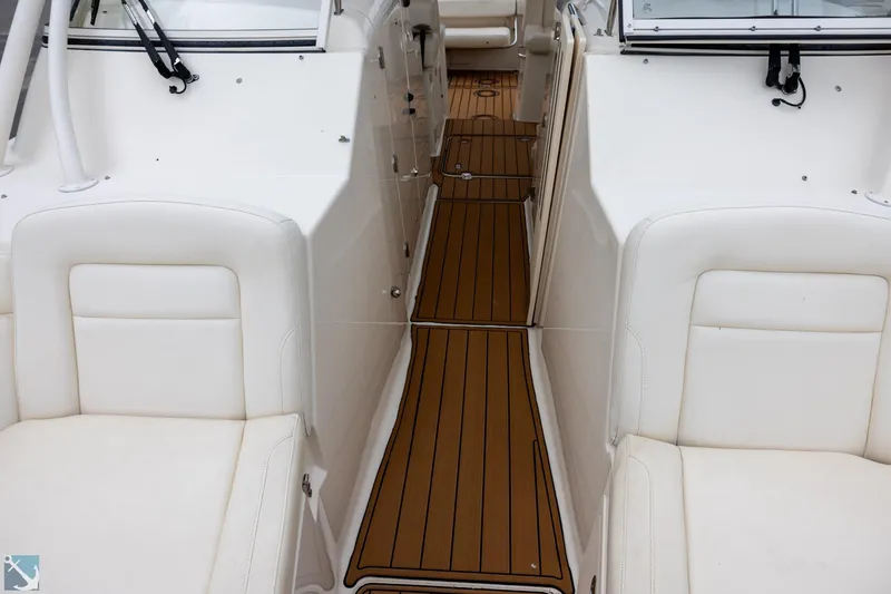 Slide: The Image of 2019 Grady-White Freedom 335 boat interior with white seating and teak flooring. - 24