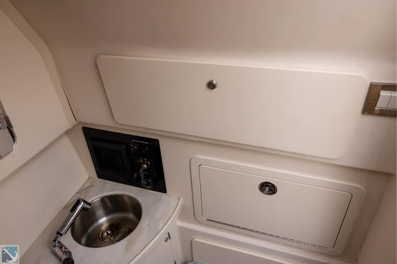 Slide: The Image of 2019 Grady-White Freedom 335 boat interior with sink and storage compartments. - 26