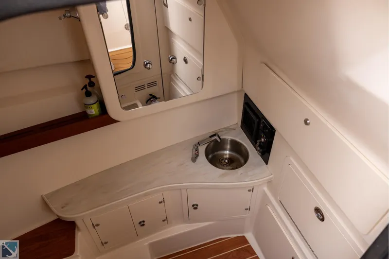 Slide: The Image of 2019 Grady-White Freedom 335 boat interior with sink and mirror in cabin. - 27