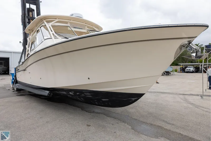 Slide: The Image of 2019 Grady-White Freedom 335 boat on a lift, showcasing sleek design and craftsmanship. - 4