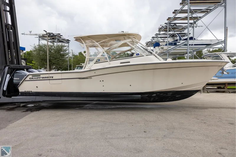 Slide: The Image of 2019 Grady-White Freedom 335 boat on a lift, side view. - 5