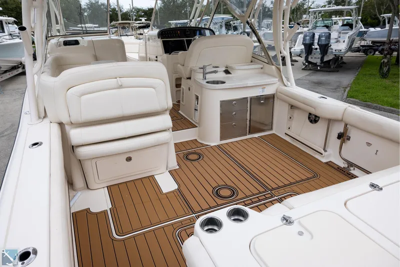 Slide: The Image of 2019 Grady-White Freedom 335 boat interior with teak flooring and white seating. - 7