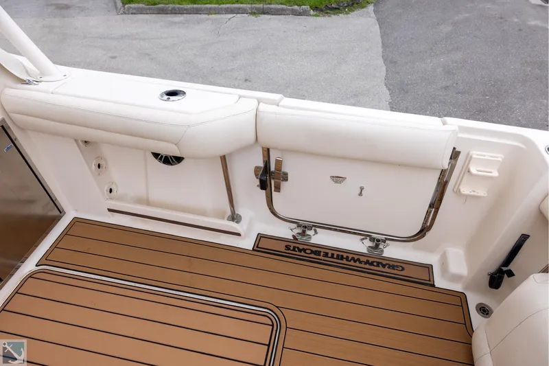 Slide: The Image of 2019 Grady-White Freedom 335 boat deck with cushioned seating and teak flooring. - 9