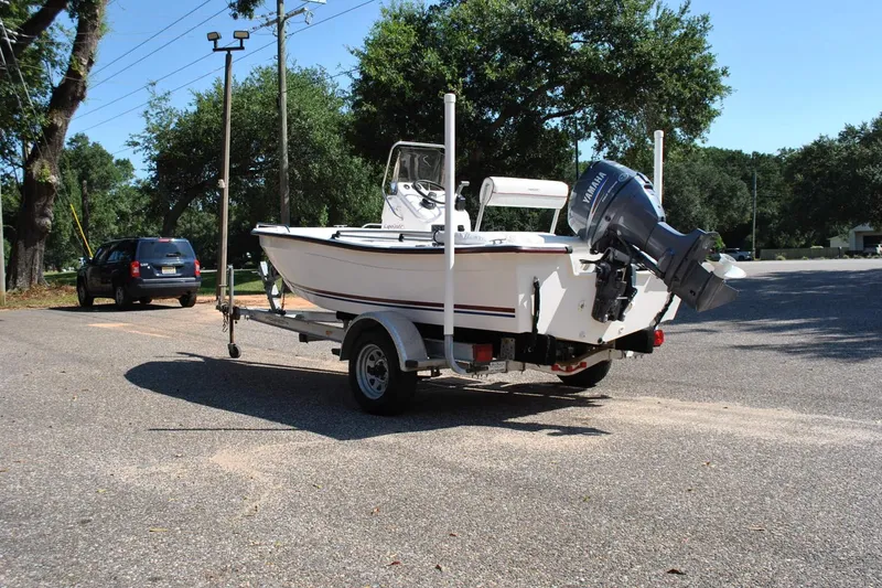 Slide: The Image of 2003 Cape Craft 16 boat on trailer with Yamaha outboard motor in parking lot. - 10