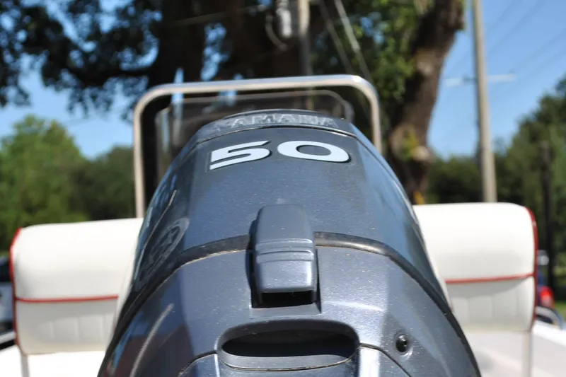 Slide: The Image of Outboard motor on a 2003 Cape Craft 16 boat, sunny day background. - 14