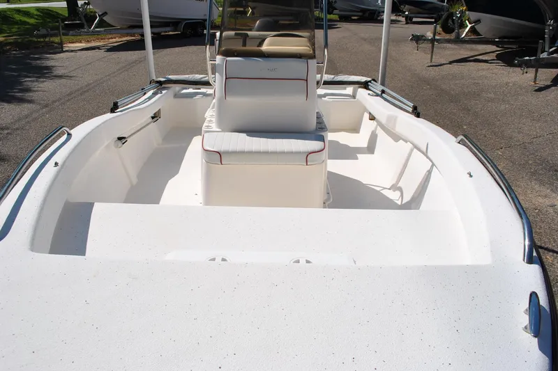 Slide: The Image of 2003 Cape Craft 16 boat interior with seating and steering console, parked on a trailer. - 15