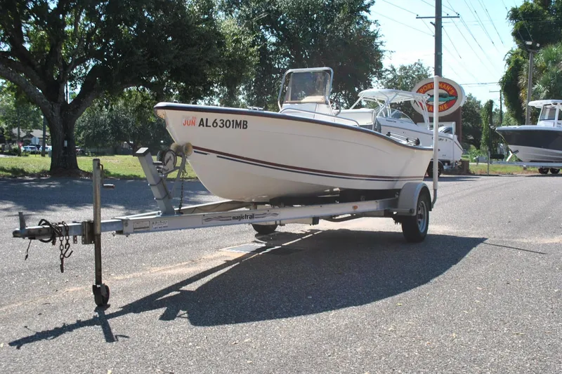 Slide: The Image of 2003 Cape Craft 16 boat on trailer in sunny outdoor setting. - 2