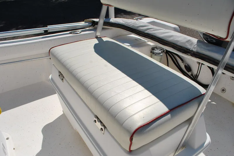 Slide: The Image of 2003 Cape Craft 16 boat interior with cushioned seating and storage compartment. - 20