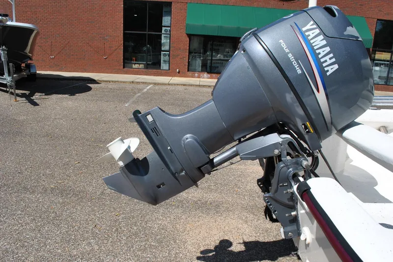 Slide: The Image of 2003 Cape Craft 16 boat with Yamaha four-stroke outboard motor in a parking lot. - 24