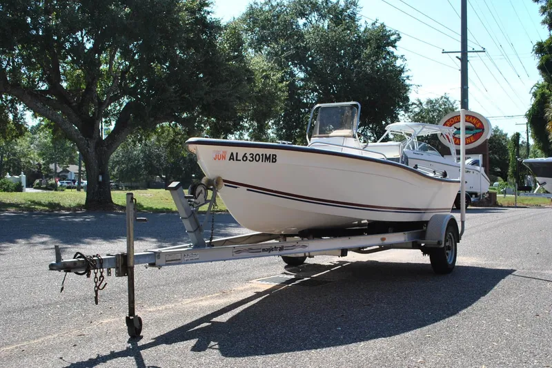 Slide: The Image of 2003 Cape Craft 16 boat on trailer, parked outdoors under trees. - 3