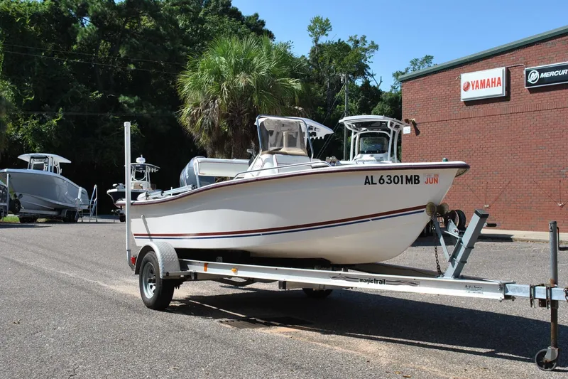 Slide: The Image of 2003 Cape Craft 16 boat on trailer, parked near Yamaha and Mercury signs. - 5