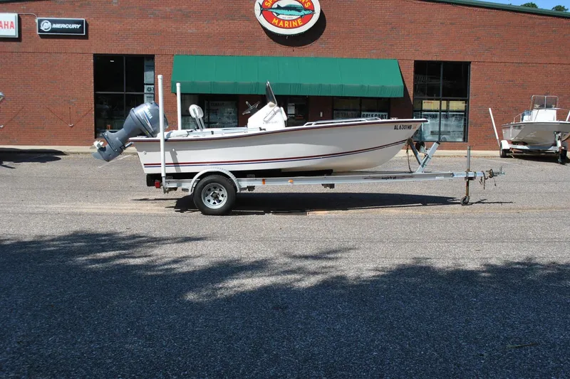 Slide: The Image of 2003 Cape Craft 16 boat on trailer outside marine store. - 6