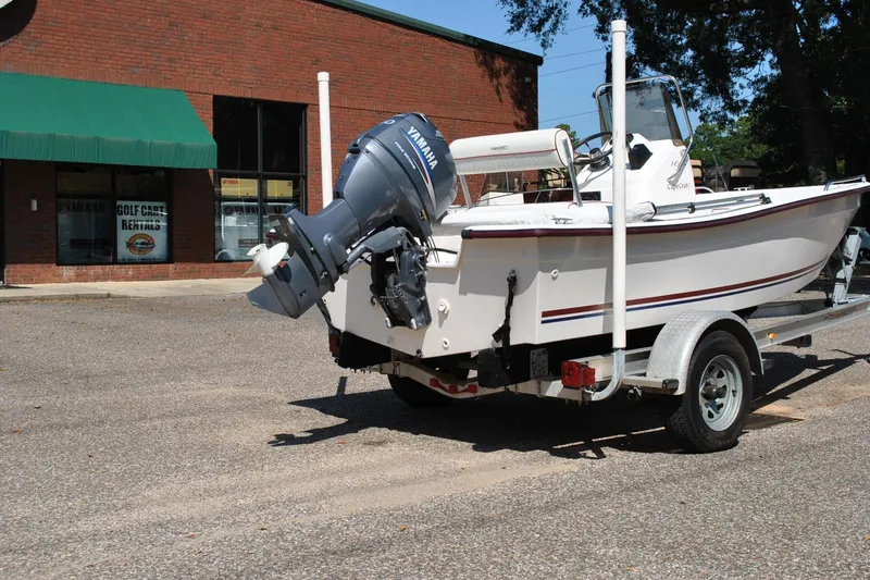Slide: The Image of 2003 Cape Craft 16 boat on trailer with Yamaha outboard motor, parked near rental shop. - 8