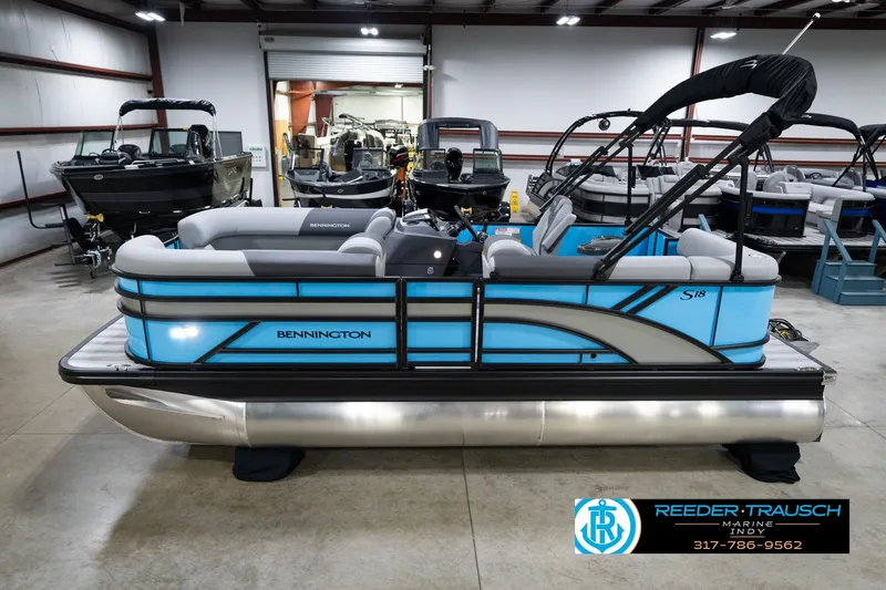 The Image of 2026 Bennington 188 SL pontoon boat in showroom, featuring sleek blue design. - 1