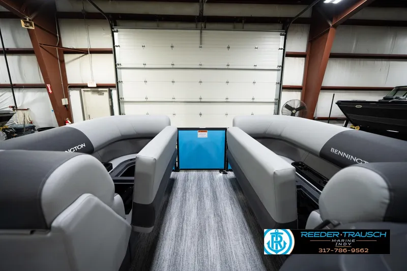 Slide: The Image of 2026 Bennington 188 SL pontoon boat interior in a showroom setting. - 21