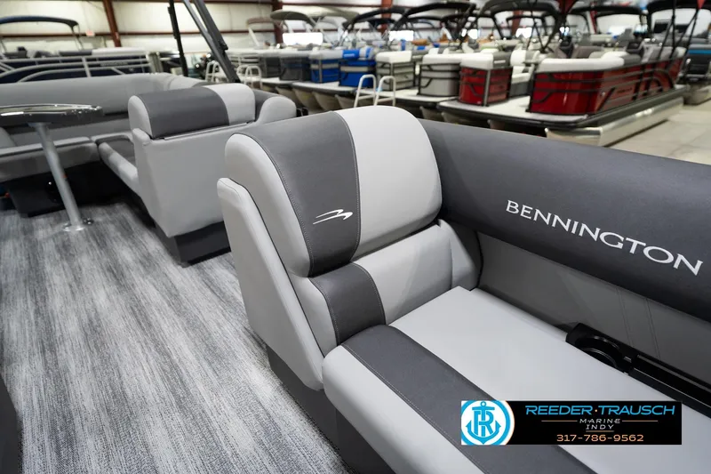 Slide: The Image of 2026 Bennington 188 SL boat interior with gray seating in showroom. - 22