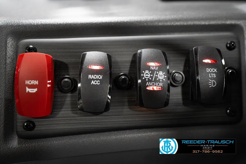 Slide: The Image of Control panel of 2026 Bennington 188 SL with horn, radio, navigation, and dock light switches. - 33