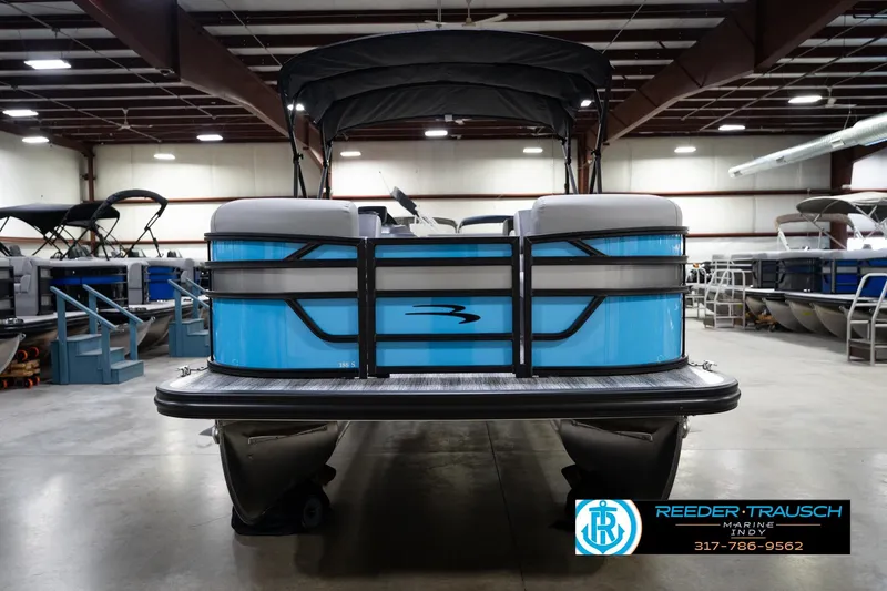 Slide: The Image of 2026 Bennington 188 SL pontoon boat in showroom, featuring sleek blue design. - 4