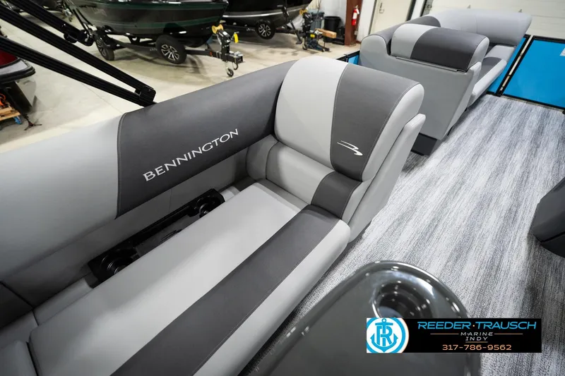 Slide: The Image of 2026 Bennington 188 SL boat interior with gray seating and logo, displayed at Reeder-Trausch Marine. - 42