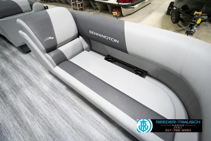 Slide: The Image of 2026 Bennington 188 SL boat interior with gray seating and logo, displayed at Reeder-Trausch Marine. - 43