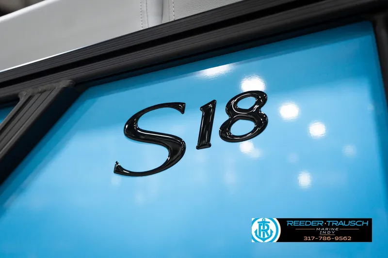 Slide: The Image of 2026 Bennington 188 SL boat with "S18" emblem on blue surface, Reeder-Trausch Marine logo. - 49