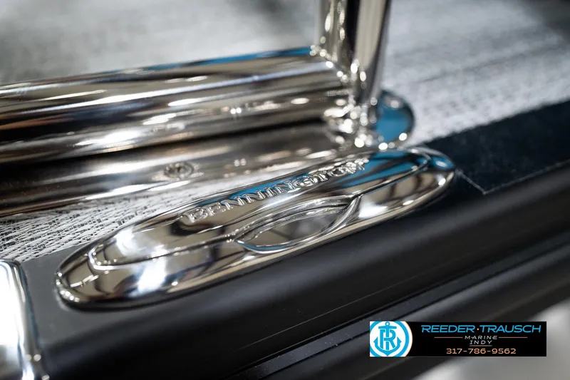 Slide: The Image of Close-up of 2026 Bennington 188 SL boat chrome detailing, featuring Reeder-Trausch Marine logo. - 51