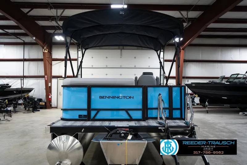 Slide: The Image of 2026 Bennington 188 SL pontoon boat in a showroom with canopy and blue exterior. - 8