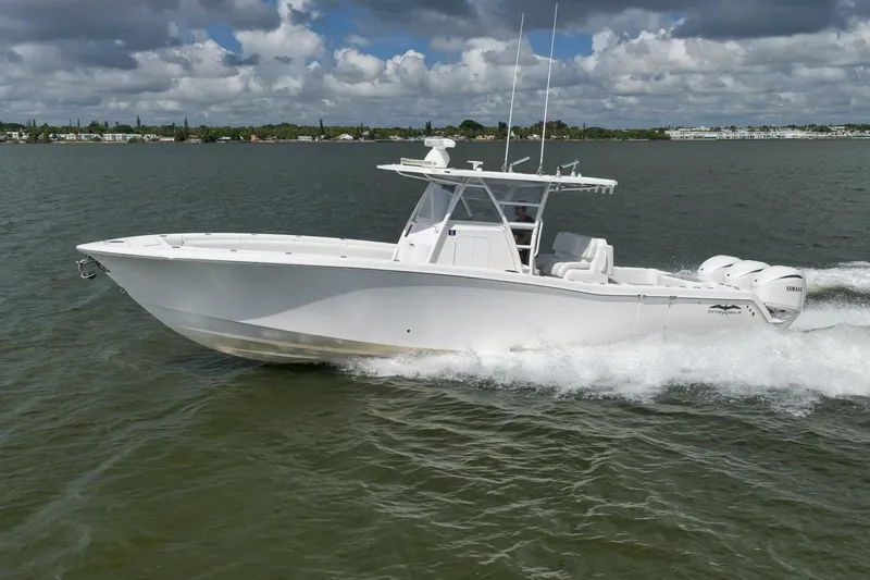 Slide: The Image of 2018 Invincible 36' Open Fisherman boat cruising on water under cloudy sky. - 13