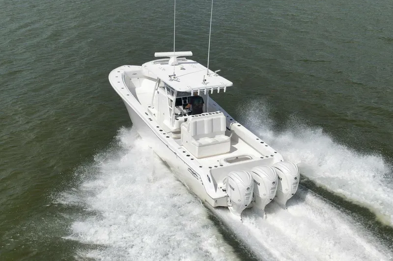 Slide: The Image of 2018 Invincible 36' Open Fisherman boat cruising on water with four engines. - 14
