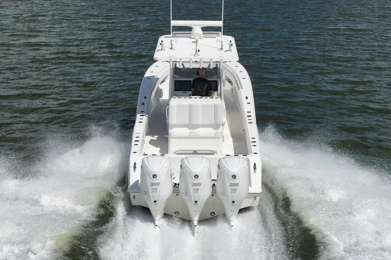 Slide: The Image of 2018 Invincible 36' Open Fisherman boat cruising on water, rear view. - 15