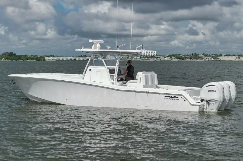 Slide: The Image of 2018 Invincible 36' Open Fisherman boat on calm water, featuring Yamaha engines. - 2