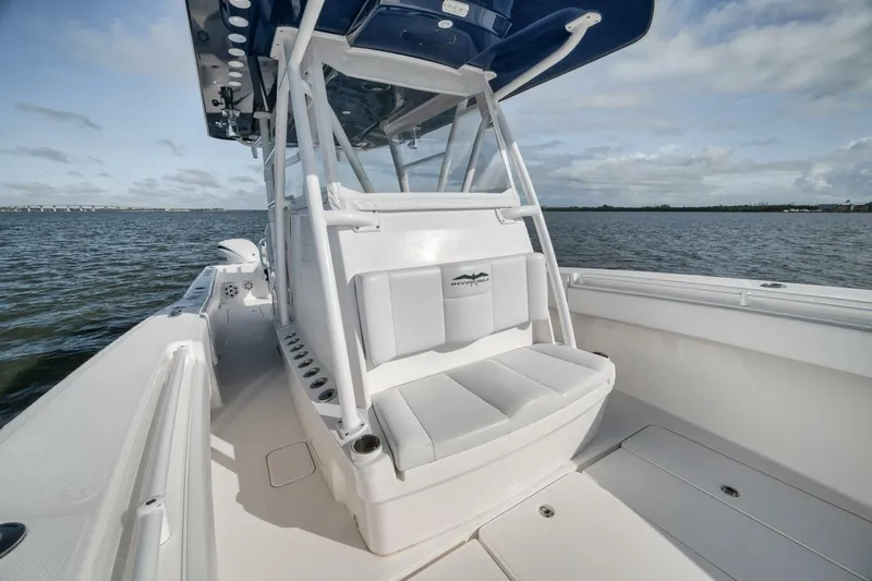 Slide: The Image of 2018 Invincible 36' Open Fisherman boat on water, showcasing seating and console. - 20