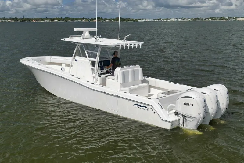 Slide: The Image of 2018 Invincible 36' Open Fisherman boat with triple Yamaha engines on calm water. - 3