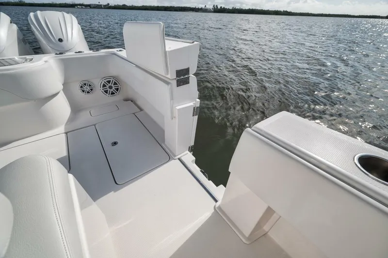Slide: The Image of 2018 Invincible 36' Open Fisherman boat interior with ocean view, featuring sleek white design. - 36
