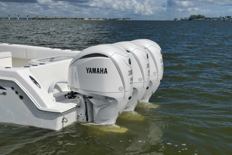 Slide: The Image of 2018 Invincible 36' Open Fisherman with triple Yamaha outboard engines on water. - 5