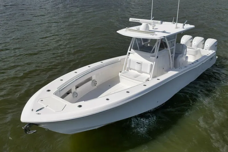 Slide: The Image of 2018 Invincible 36' Open Fisherman boat on water, featuring sleek design and triple engines. - 7