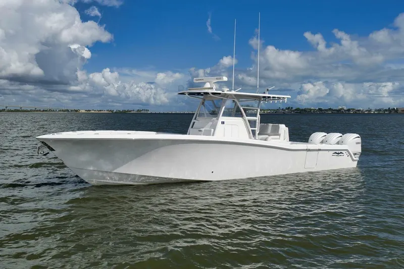 Slide: The Image of 2018 Invincible 36' Open Fisherman boat on calm water under a cloudy sky. - 8