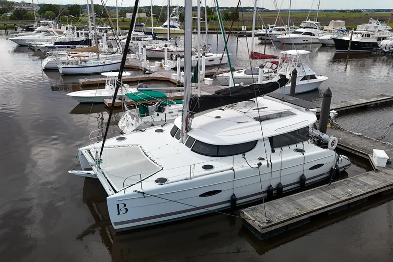 The Image of 2013 Fountaine Pajot Lipari 41 catamaran docked at a marina with other boats. - 0