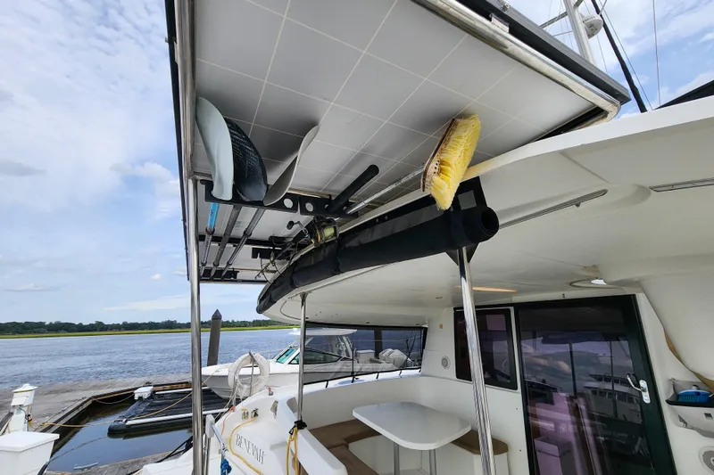 Slide: The Image of 2013 Fountaine Pajot Lipari 41 catamaran with solar panels and deck equipment, docked by the water. - 20