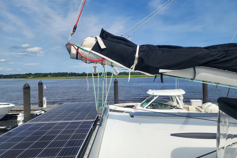 Slide: The Image of 2013 Fountaine Pajot Lipari 41 catamaran with solar panels docked by the water. - 22