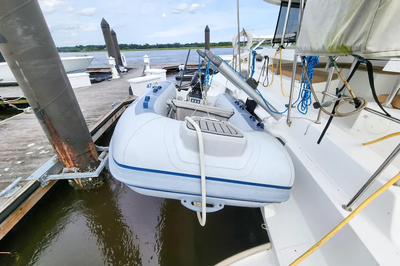 Slide: The Image of 2013 Fountaine Pajot Lipari 41 catamaran with dinghy docked at marina. - 27