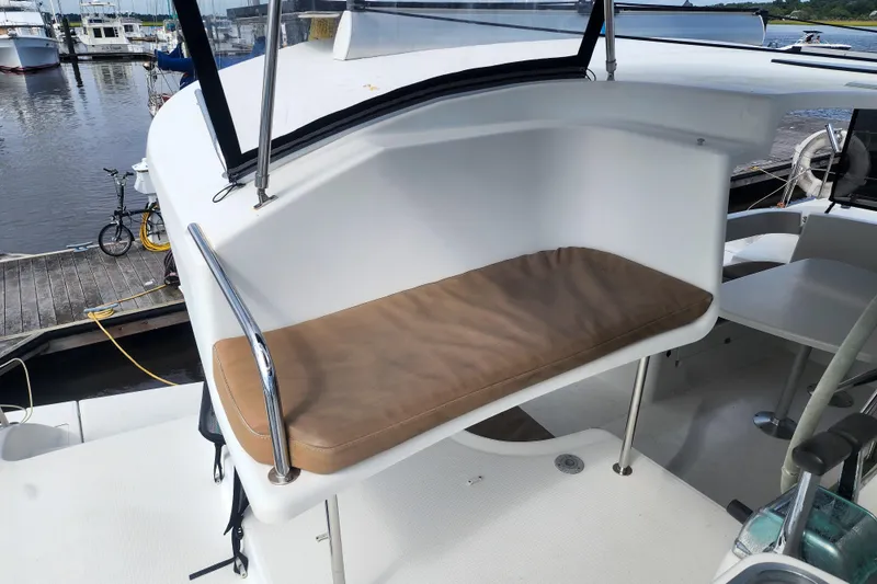 Slide: The Image of 2013 Fountaine Pajot Lipari 41 catamaran helm seat with cushion, docked at marina. - 34