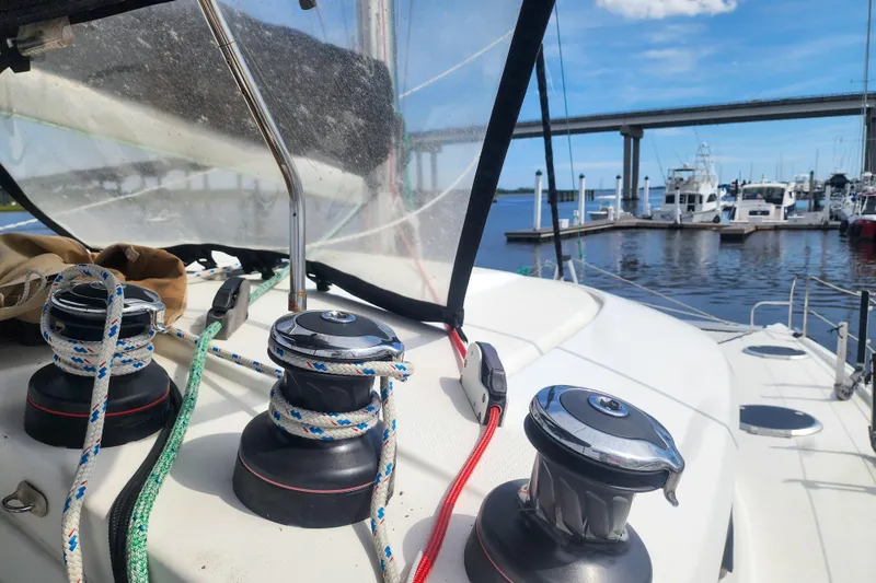 Slide: The Image of Fountaine Pajot Lipari 41 sailboat deck with winches and ropes, docked at marina, 2013 model. - 36