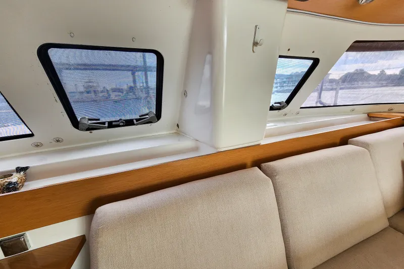 Slide: The Image of Interior of 2013 Fountaine Pajot Lipari 41 catamaran, featuring windows and beige seating. - 42