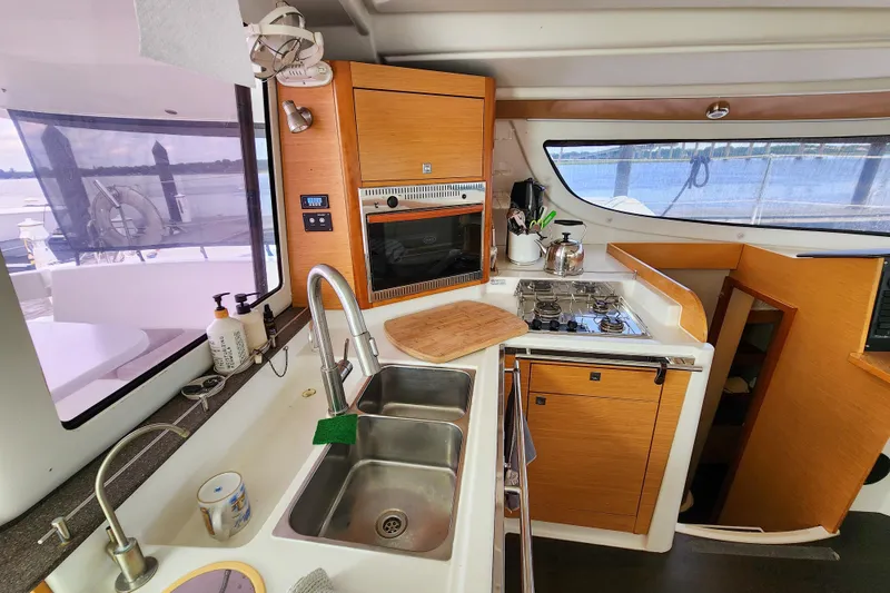 Slide: The Image of Modern kitchen interior of 2013 Fountaine Pajot Lipari 41 catamaran with wood cabinetry. - 44