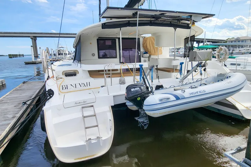 Slide: The Image of 2013 Fountaine Pajot Lipari 41 catamaran docked with inflatable boat attached. - 6