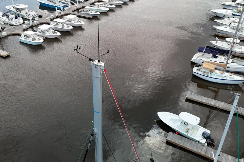 Slide: The Image of 2013 Fountaine Pajot Lipari 41 catamaran docked at a marina with multiple boats. - 62