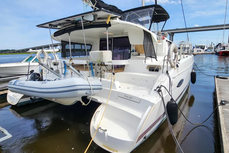 Slide: The Image of 2013 Fountaine Pajot Lipari 41 catamaran docked with inflatable dinghy attached. - 7